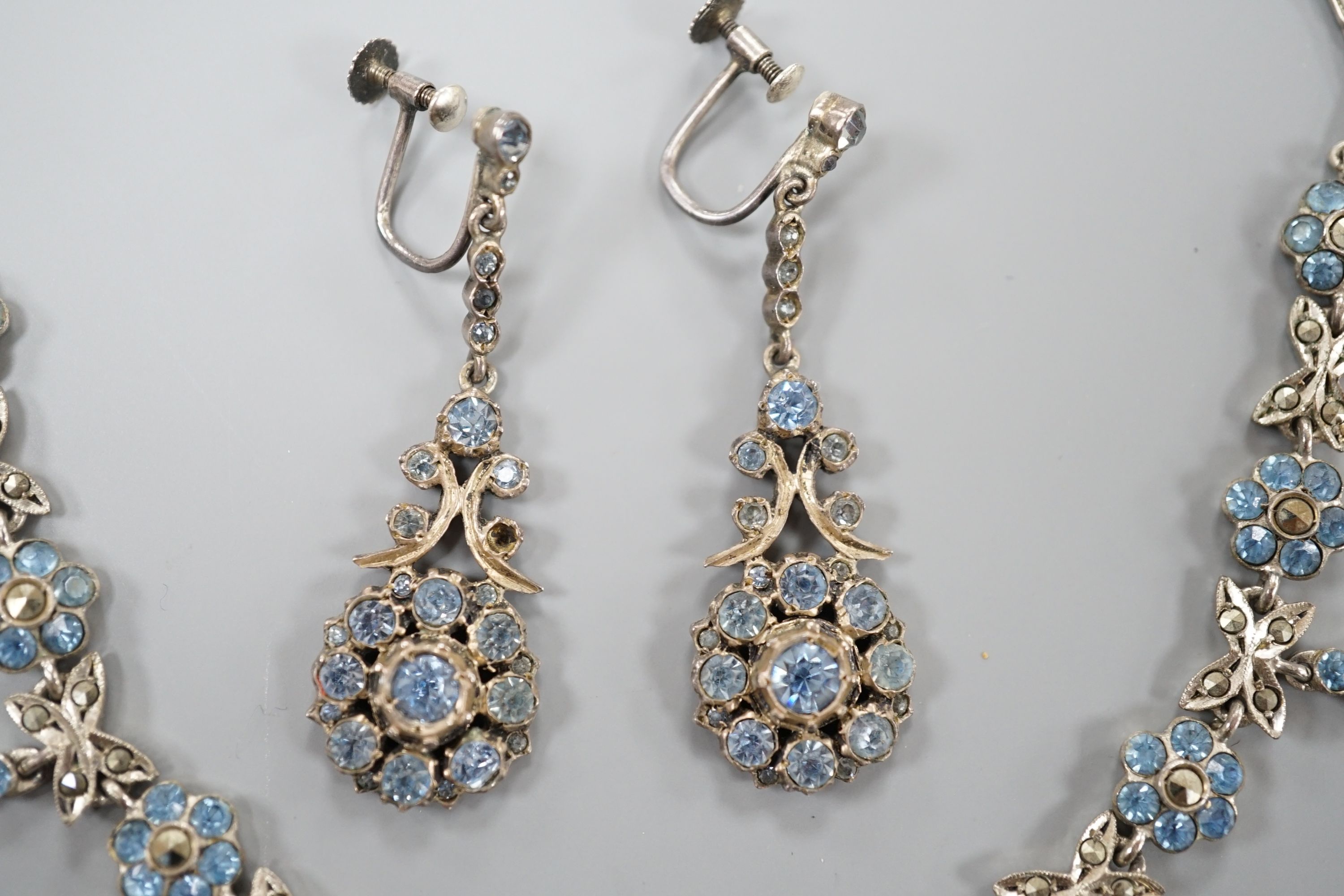 A base metal, marcasite and blue paste set necklace and pair of matching drop earrings, necklace 41cm, earrings 42mm.